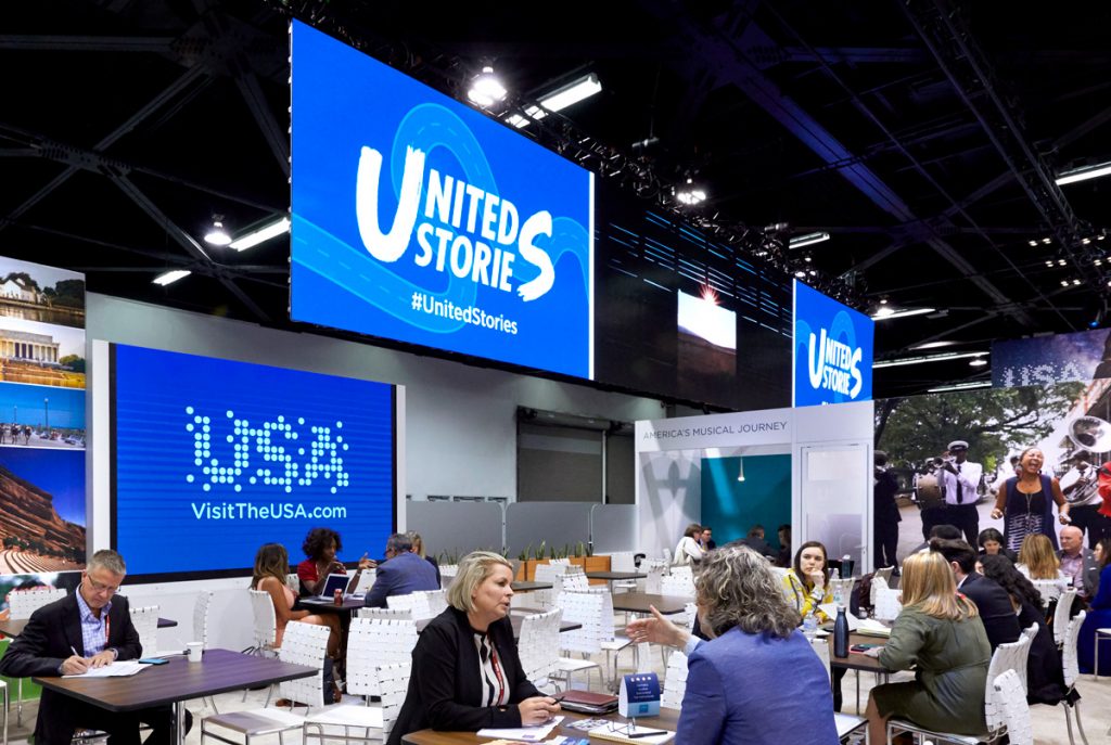 Digital screens positioned throughout the Brand USA booth